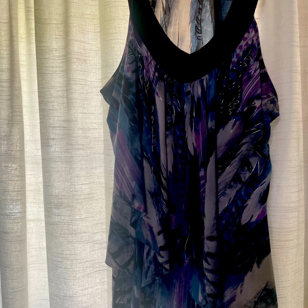 Vneck abstract feather print, sleeveless, ruffled top.  Appropriate for evening.